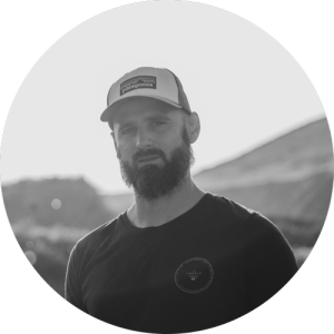 A man with a cap on looking at the camera (Rich), our CFO in black and white 