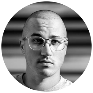 A man looking at the camera (Tim), our Managing Consultant in black and white 